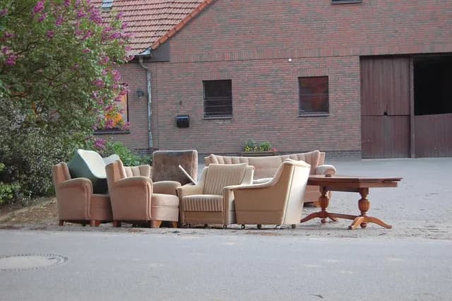 Alte Sessel, Sofas und ein Holztisch als Sperrmüll am Straßenrand – professionelle Entrümpelung und Entsorgung durch Family Umzüge